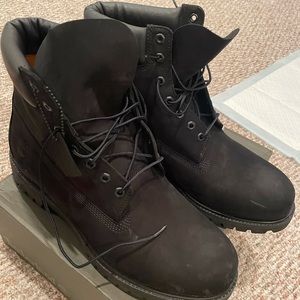 All black Timberland boots with cleaning kit